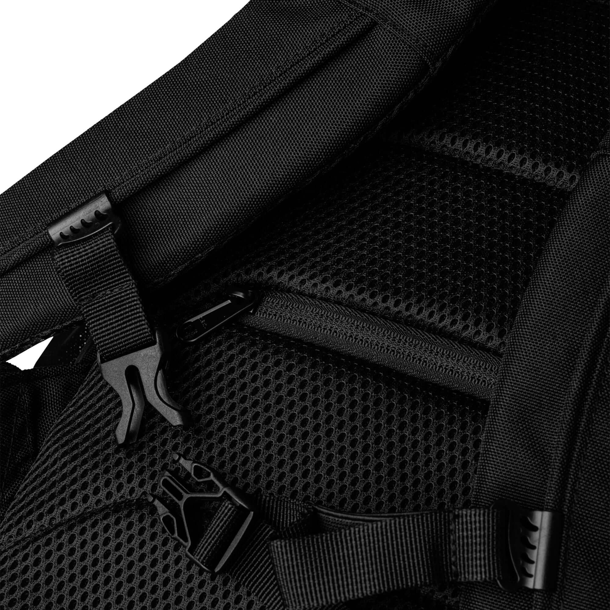 Close-up view of black Divitia utility backpack with adjustable straps and breathable back panel